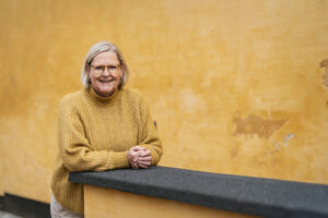 Winnie Synia fotograferer brandingprofil for karrierekonsulent inde i byen i Odense på en gul væg